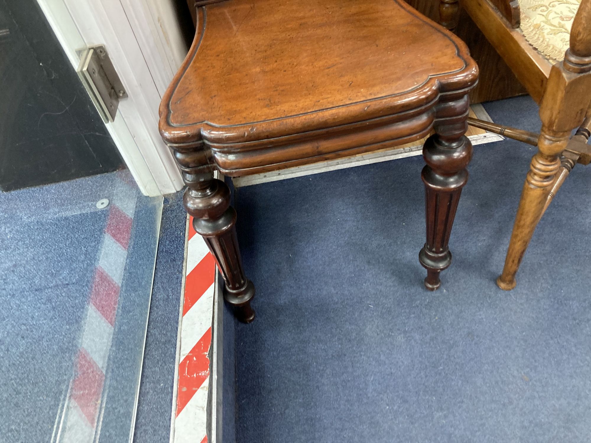 A Victorian mahogany hall chair and an Edwardian mahogany corner elbow chair